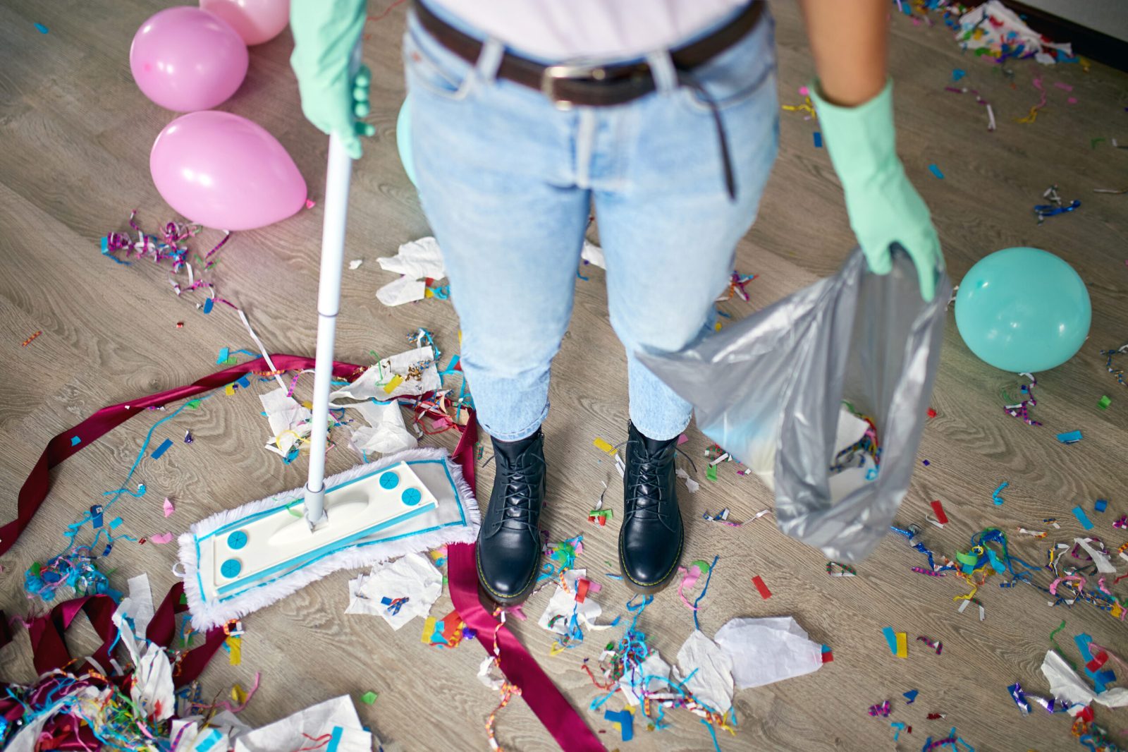 woman-with-pushbroom-cleaning-mess-of-floor-in-roo-2023-11-27-05-00-05-utc